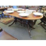 A "D" end extendable dining table, twin pedestal base, claw feet and castors,