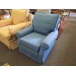 A blue upholstered armchair,