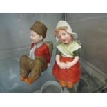 Gebruder Heubach bisque Dutch style pair of seated child figurines with flower baskets,