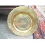 A brass dish with longboat design,