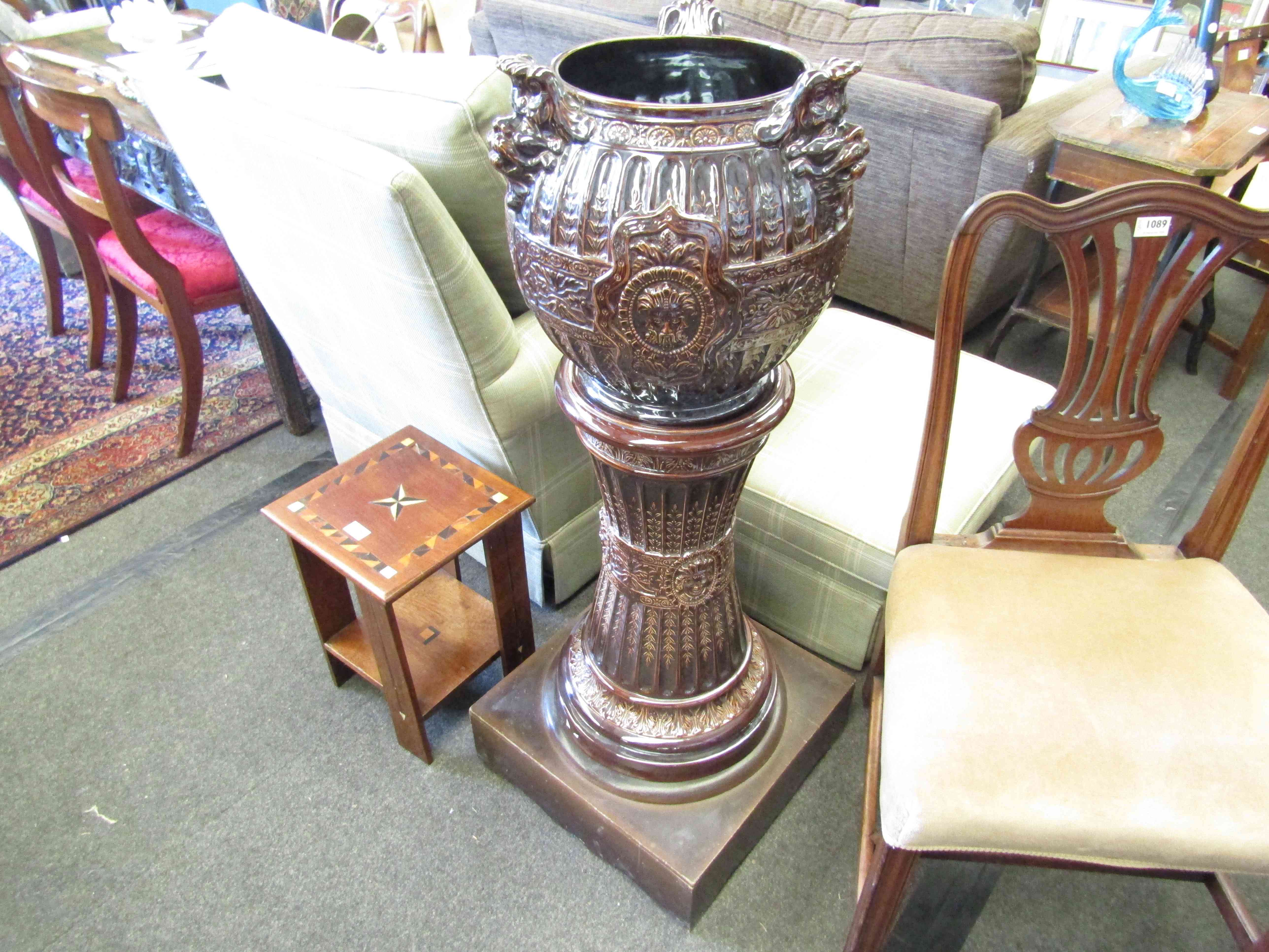 A 19th Century French glazed jardiniere on stand with lion mask details,