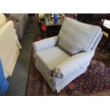 A powder blue armchair with fern leaf pattern,