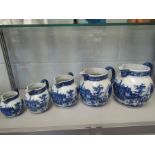 A set of five blue and white graduated jugs 'Victoria Ware' ironstone transfer