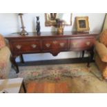 An oak three drawer sideboard on cabriole legs,