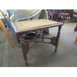 An Anglo-Indian carved table with rectangular top and inlaid brass tray,