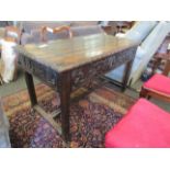 An early to mid 19th Century carved oak side table, heavily carved frieze,