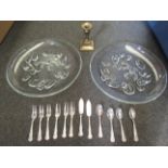 A pair of glass dishes, brass squat candlestick and plated teaspoons,
