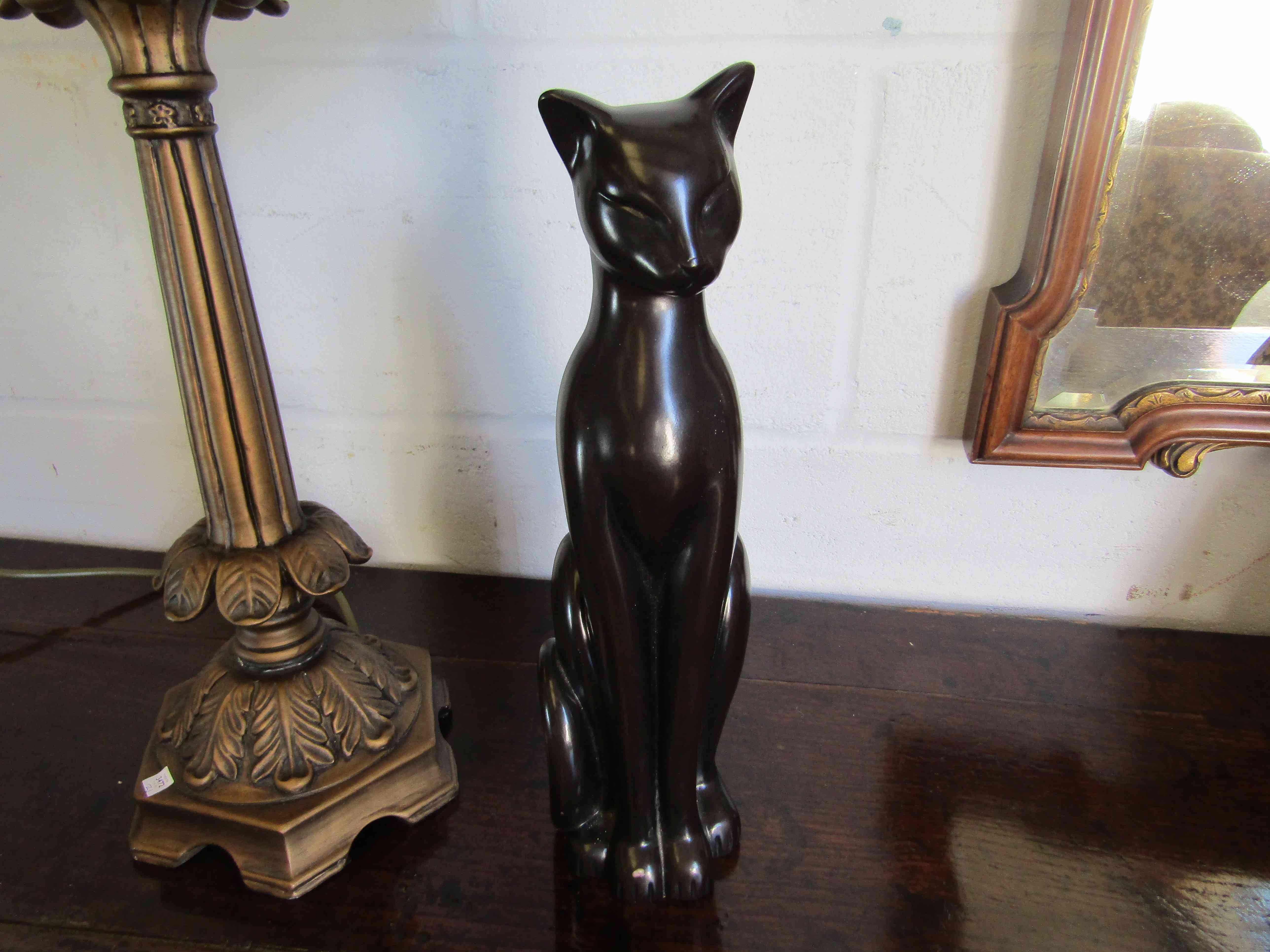 A stylised seated cat figure,