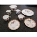 An Edwardian china part tea service painted with birds, comprising four cups, two saucers,