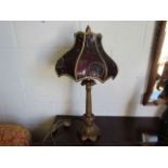 A table lamp with lined Eastern style shade,