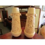 A pair of cream glazed ceramic vases with scenes of flowers and maidens,