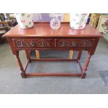 An oak two drawer hall table on stretcher base,