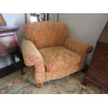 A pair of upholstered swag design armchairs on castors