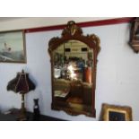 A gilt and mahogany wall mirror with bevel edge,