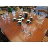 An assortment of drinking glasses and two glass bottles etc