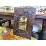 A 19th Century deep carved oak mirror,