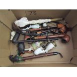 A box of vintage smoker's pipes
