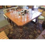 A Victorian mahogany telescopic dining table on finely fluted baluster legs with three extra leaves