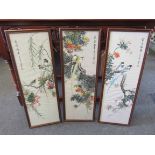 A set of three Oriental bird and foliage design silk pictures, framed and glazed,