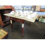 A dropflap mahogany table with painted top on ring turned legs to castors,