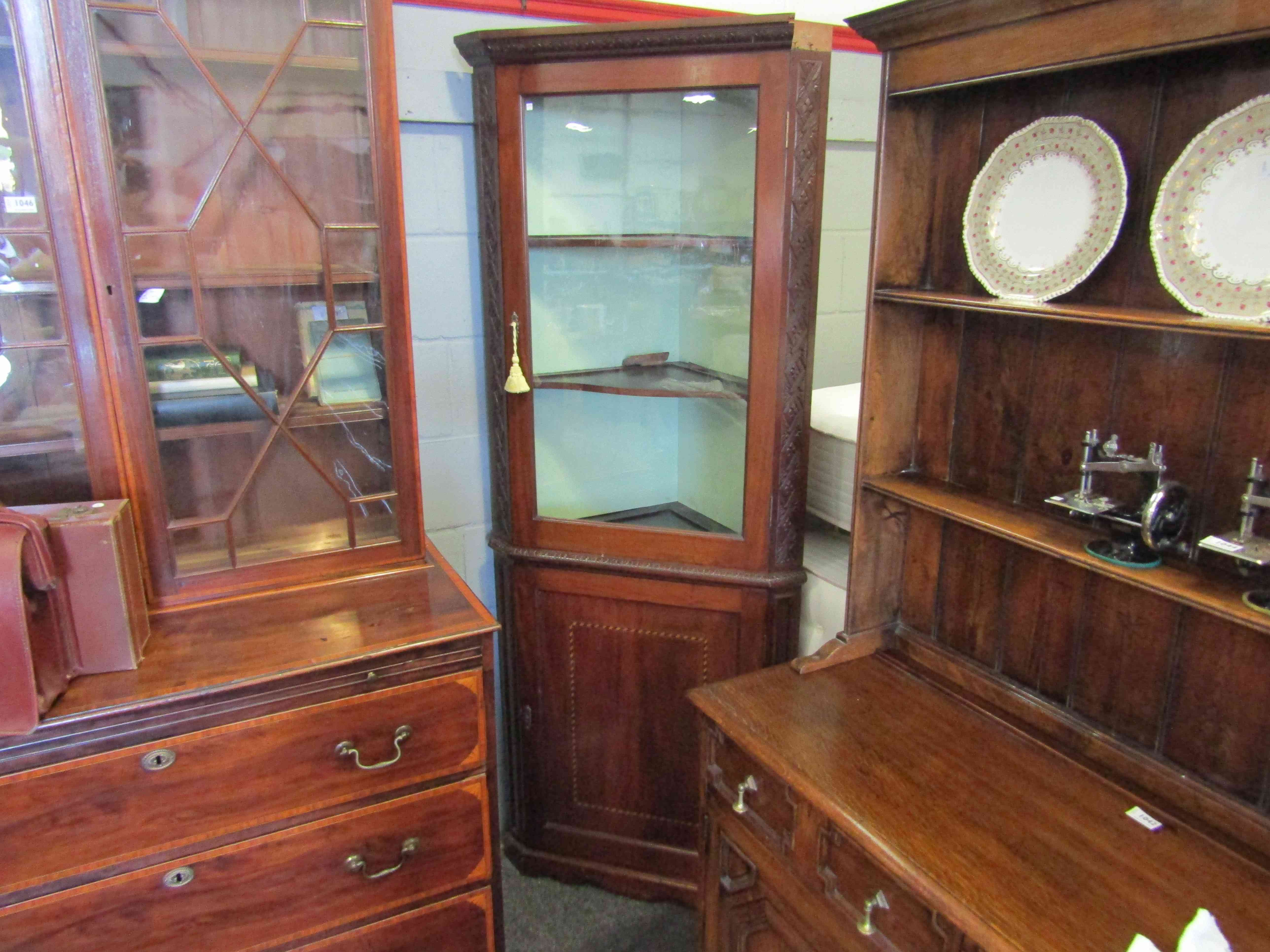 A 19th century mahogany corner cabinet with inlay and glazed door, cornice a/f,