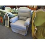 A pale blue upholstered armchair,