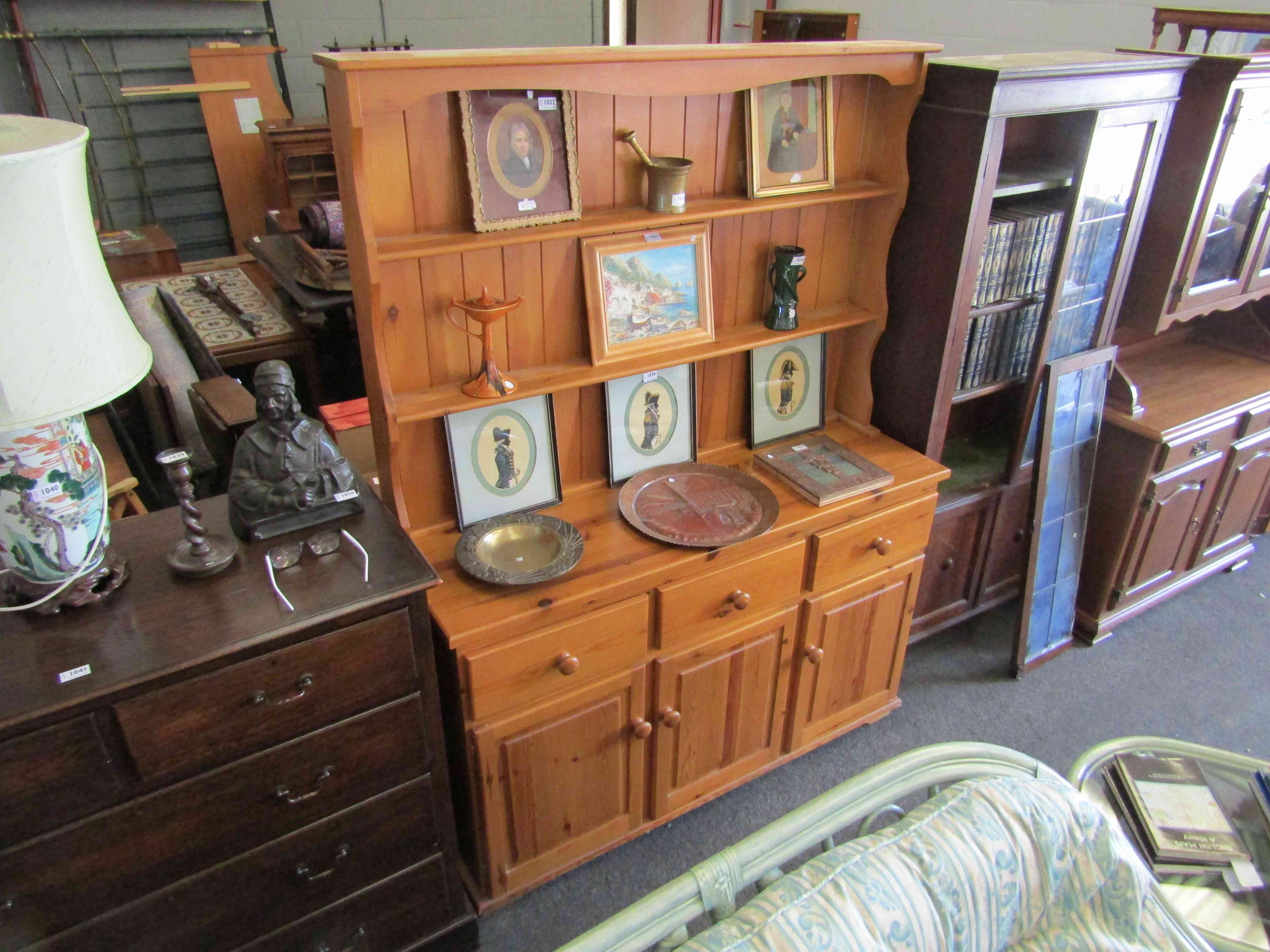 A modern pine dresser with plate rack top,