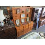 A modern pine dresser with plate rack top,