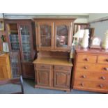 A modern dresser with glazed top on two drawer over two door base,