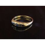 A gold ring set with five sapphires in rubover setting. Size O, 2.