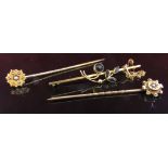 Two gold stick pins both with seed pearls and a gold brooch, unmarked,