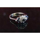 An 18ct white gold diamond and sapphire cluster ring. Size Q, 3.