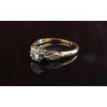A gold diamond solitaire with diamond set shoulders .20ct approx. Size Q, 3.