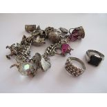 A silver charm bracelet with multiple charms including Crown, football, footballer,