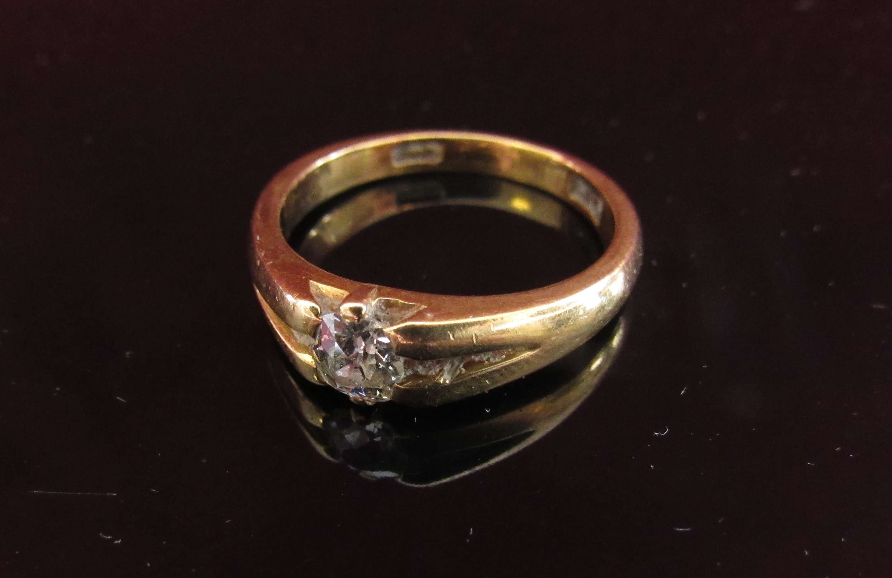 A gold ring set with a single diamond .35ct approx, stamped 18ct.