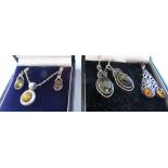 An amber pendant necklace and three pairs of amber drop earrings