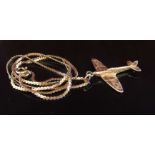 A 9ct gold pendant as a Spitfire hung on a 9ct gold neckchain, 52cm long,