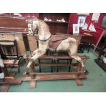 An early 20th Century Lines Bros. rocking horse with dappled painted body on trestle rocker, approx.