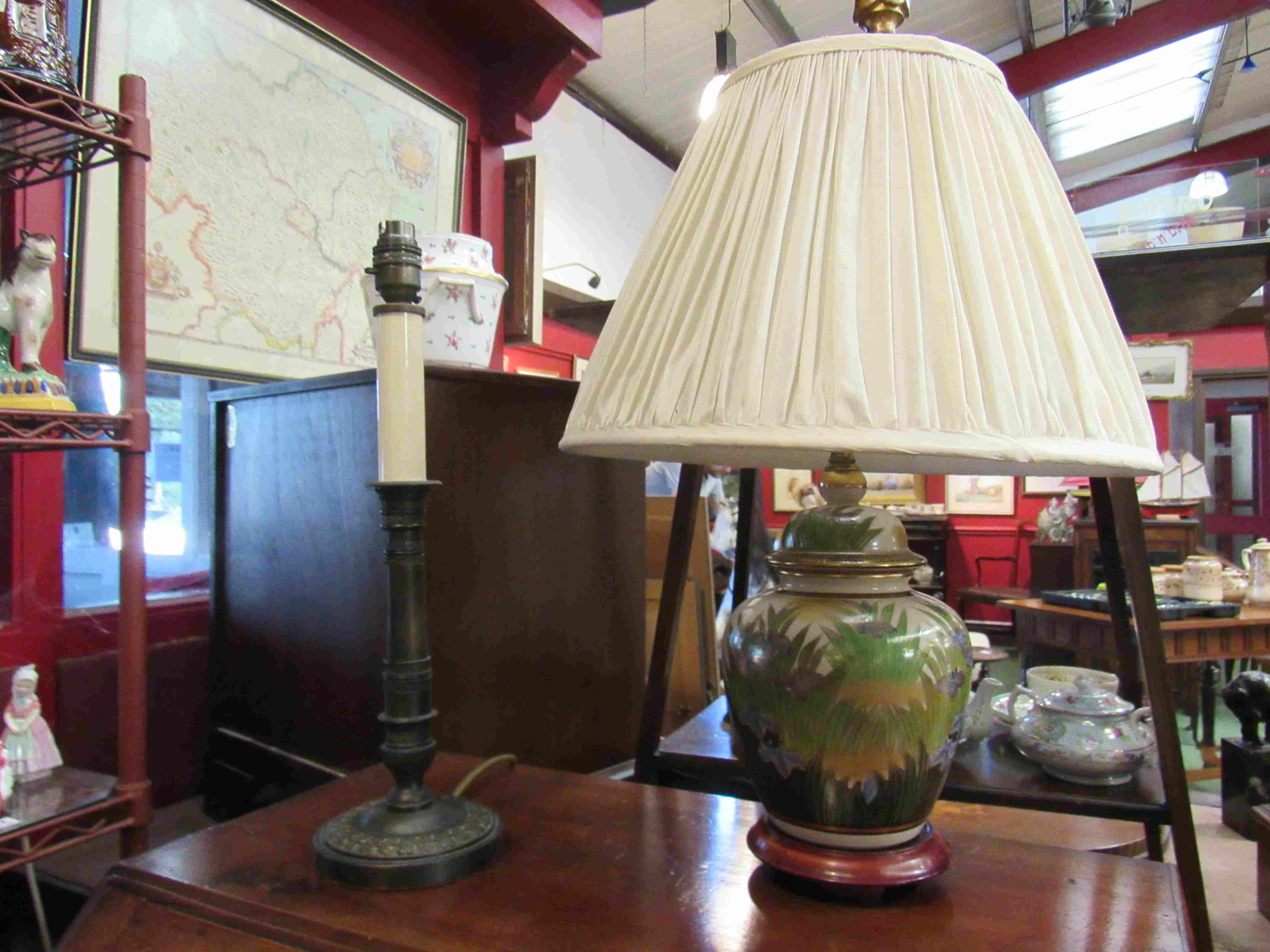 An Asian foliate design table lamp on wooden base and a brass candlestick form table lamp