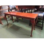 A coffee table with cabriole legs on pad feet,