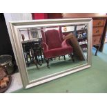 A bevel edged rectangular wall mirror in silvered colour frame,