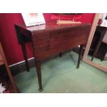 A George III mahogany Pembroke table on chamfered tapering legs and carved feet,