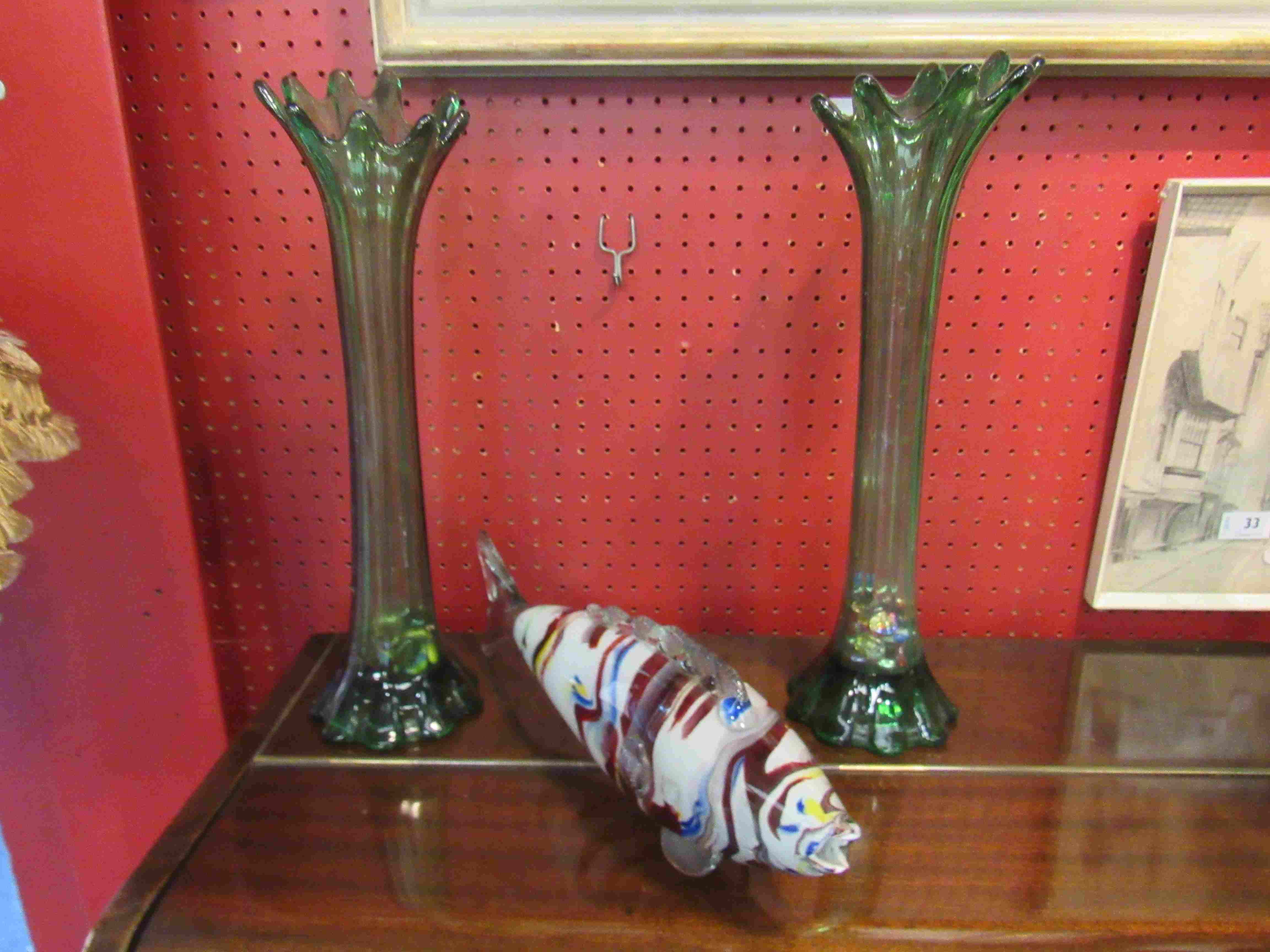 A Murano glass fish and a pair of green glass vases with decorative pebbles