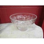 A crystal glass bowl with tapering sides,