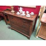 A walnut three drawer chest on bracket feet,