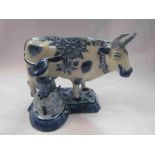 A Dutch Delft cow milking figurine,