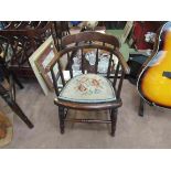 An oak Victorian child's captains chair with spindle decoration and needlepoint seat on turned legs