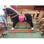 A soft filled rocking horse on oak trestle rocker,