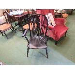 A 19th Century elm and oak wheel-back elbow chair the dished seat over turned legs joined by an 'H'