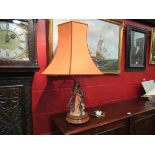 A figural table lamp, robed lady holding fruit,